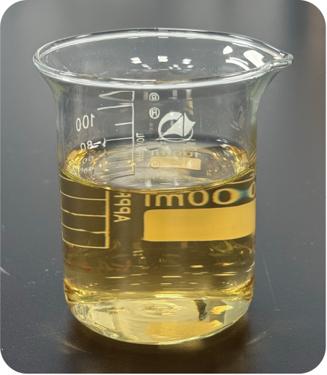 Beaker with pale yellow liquid about a third full, glass with measurement marks along the side, placed on a dark lab table.